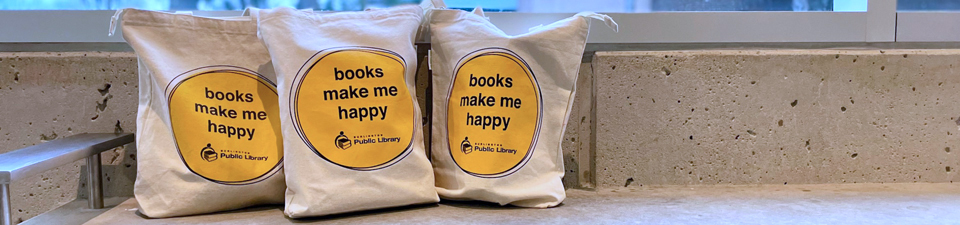 three canvas burlington public library book bags showing the phrase books make me happy