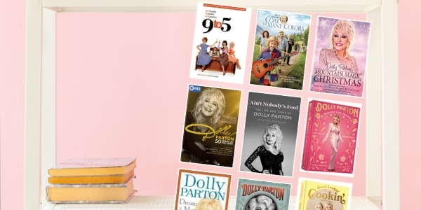 pink wall and a white bookshelf with various book covers