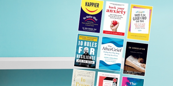 pale blue wall with white bookshelf with various book covers