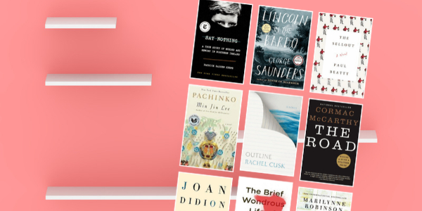 pink wall and a white bookshelf with various book covers