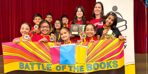 group of students holding up the Battle of the Books banner