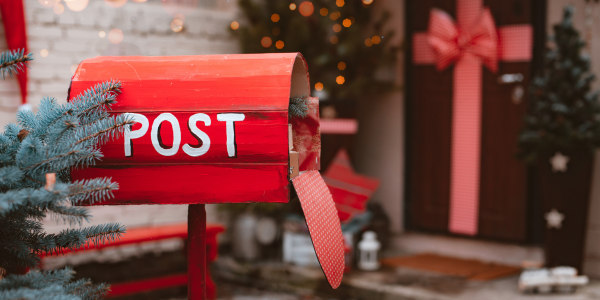 A photograph of a red mailbox. Text reads: Post.