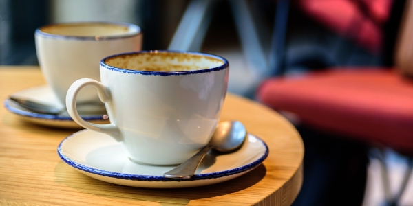two cups sitting on a cafe table