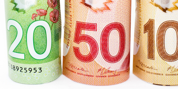 rolled up $20, $50, $100 Canadian dollar bills 