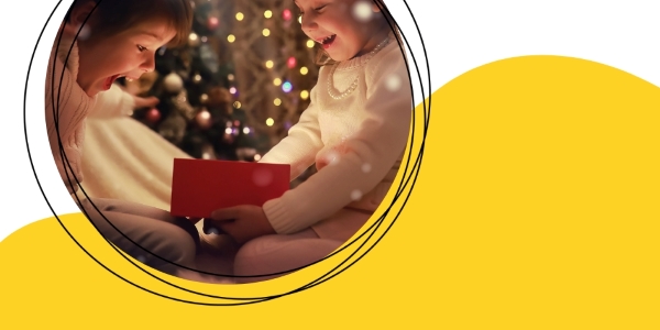  Two excited children looking into a gift box 