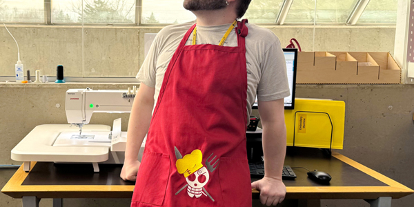adult wearing a machine embroidered apron