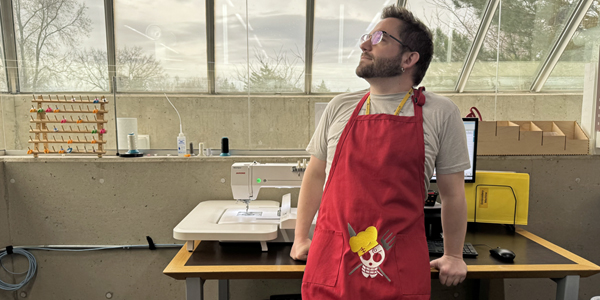 BPL staff member wearing a machine embroidered apron