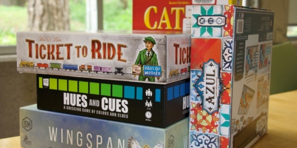 stack of five board games