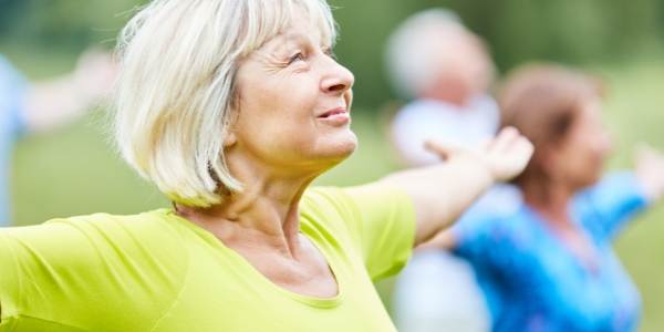 older person exercising in a group