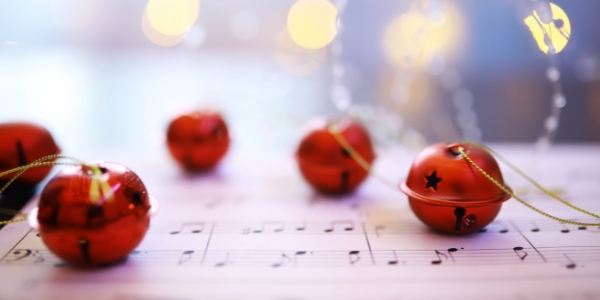 five red jingle bells on sheet music