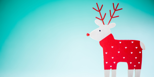 illustrated graphic of a reindeer wearing a red sweater with white hearts