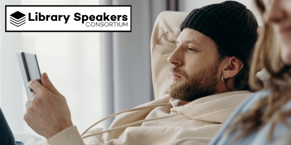 bearded adult wearing a watch cap and holding a device beside Library Speakers Consortium logo