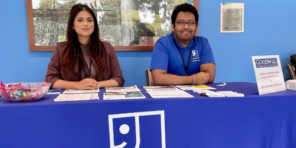 two people from Goodwill Amity sitting at a table