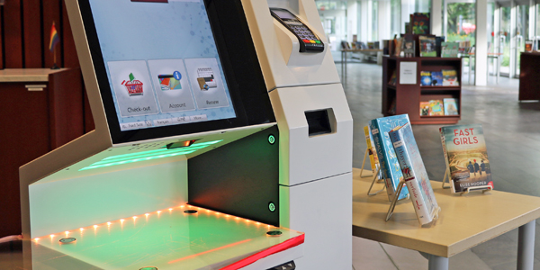 self-checkout unit and book displays in background