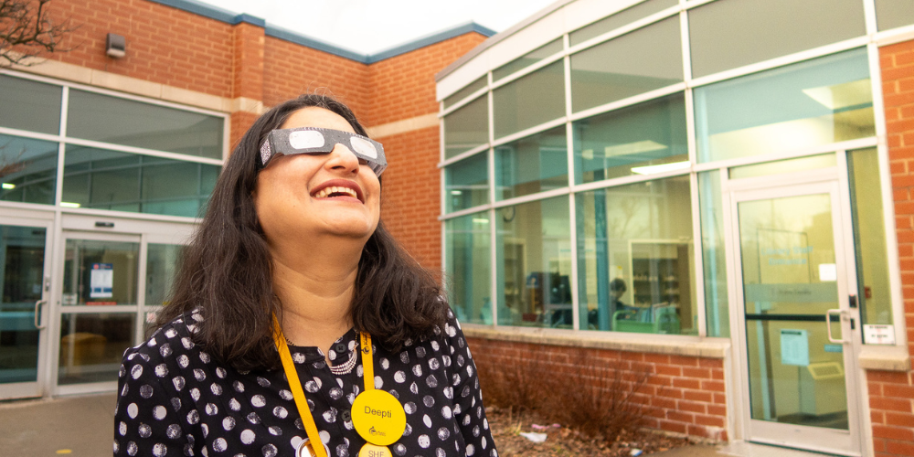 Woman wearing paper glasses looking at the sky