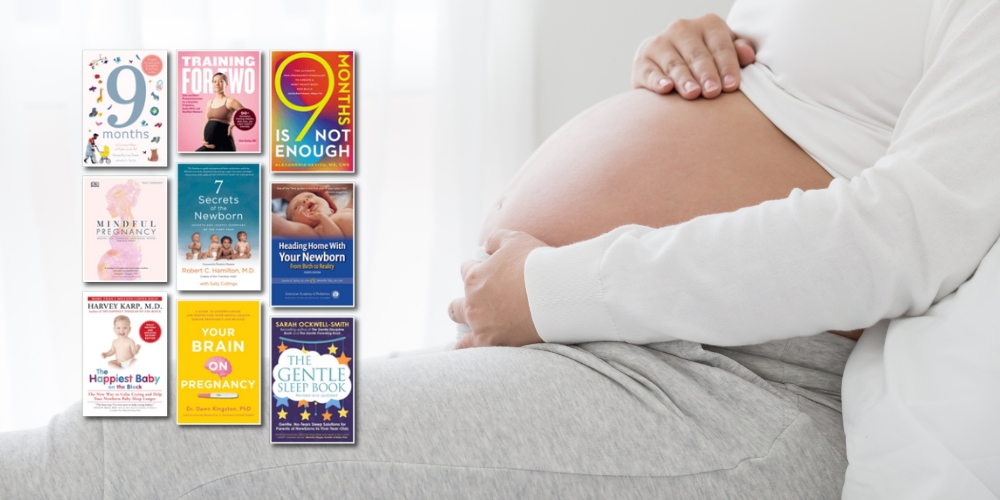 pregnant tummy beside book covers