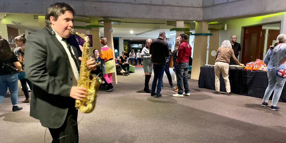 man in suit playing saxophone