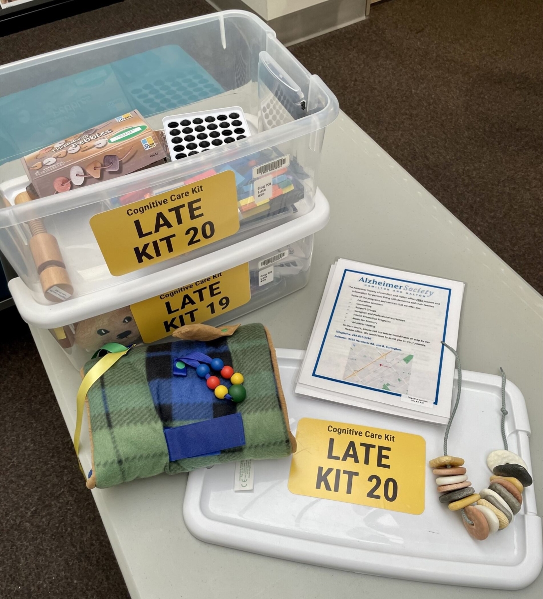 Two bins filled with puzzles and activities labelled Late Kit 20 and Late Kit 19