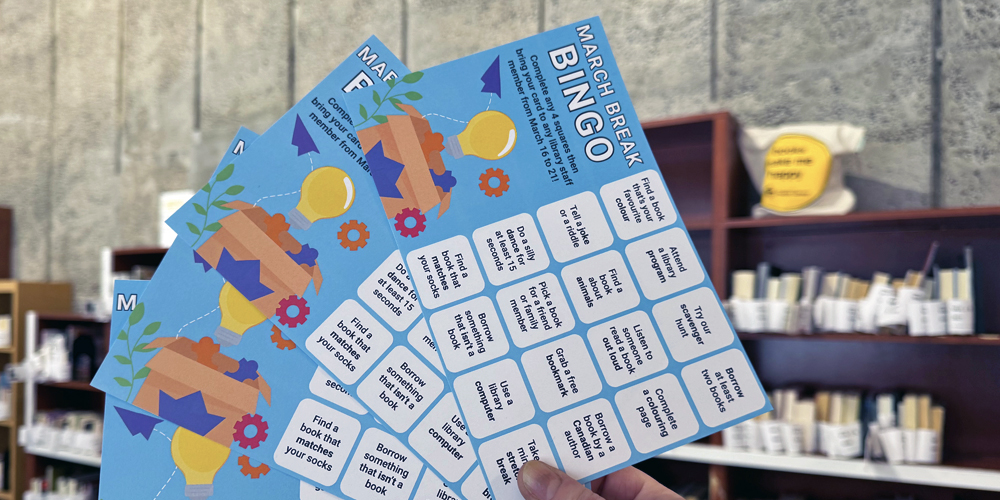 hand holding four bingo cards