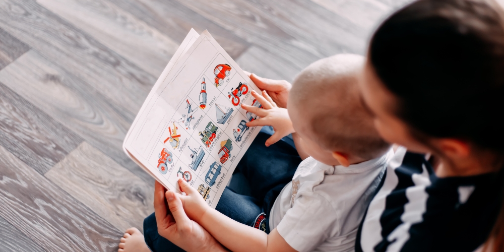 adult and child reading a picture book together