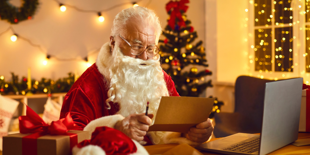 Santa writing a letter at a desk