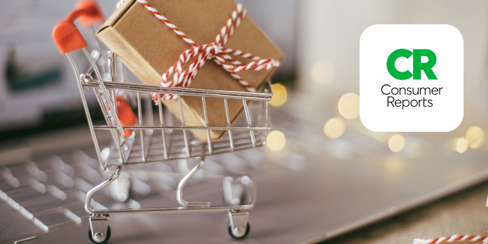 laptop and mini shopping cart holding two gifts beside Consumer Reports logo