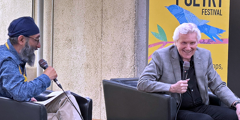 BPL events coordinator Parampreet Khanuja shares a laugh onstage with author and musician Rik Emmett during Burlington Lyrics & Poetry Festival at Central Branch.