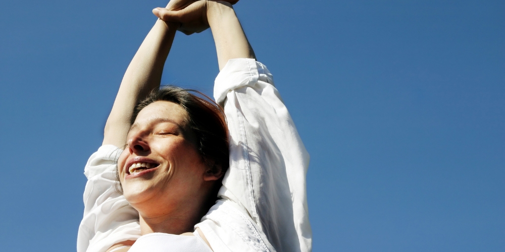 smiling adult stretching outside