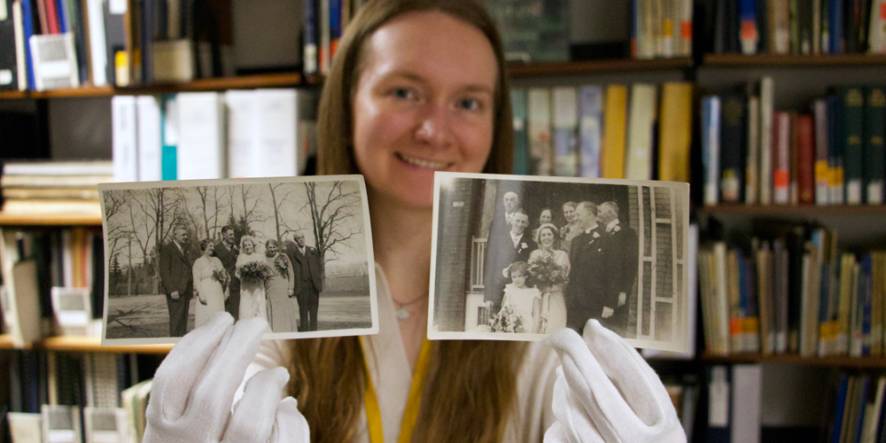 Adult holding up two old bridal party photos