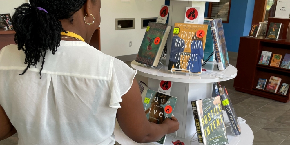 adult looking at books on display at Central Branch
