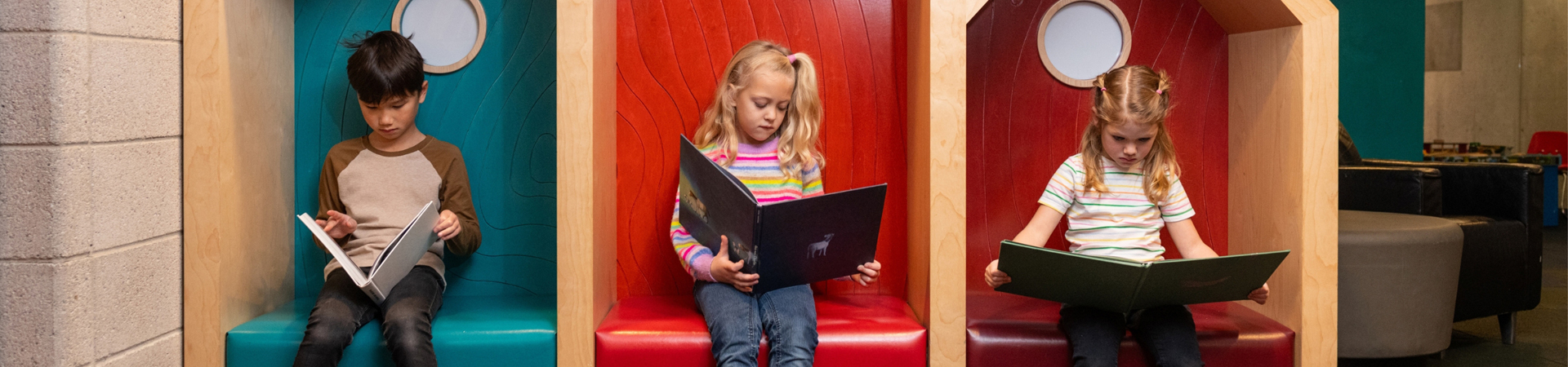 three children reading books