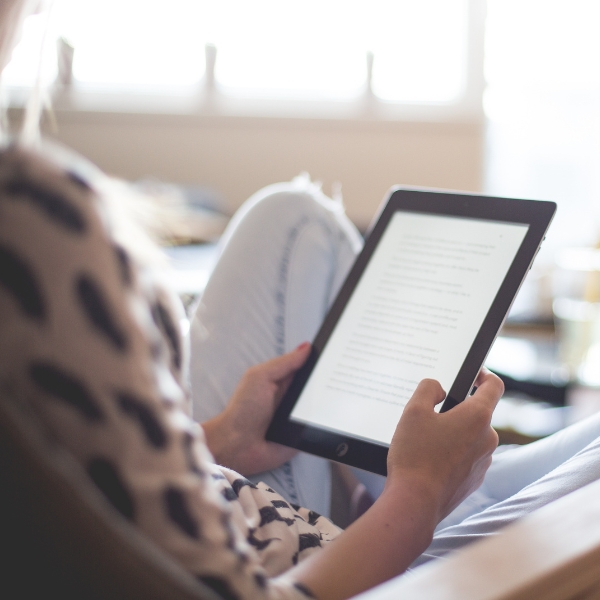 seated person looking at a tablet